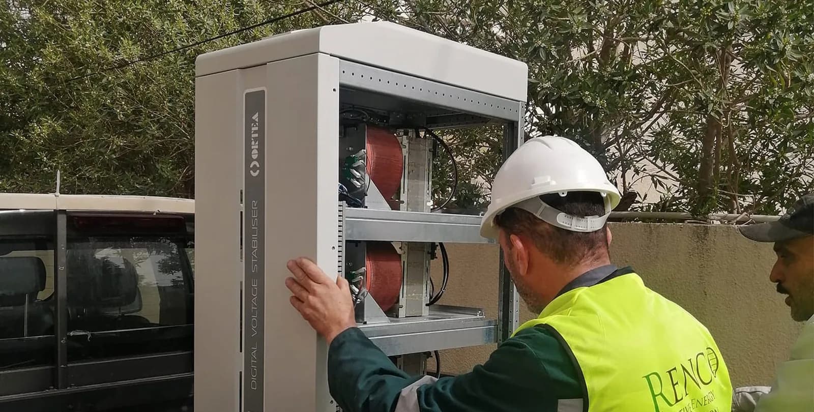 Renco technician installing a digital voltage stabiliser outdoors